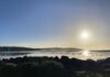 Image of beach with rocks and the sun shining